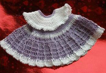 Crochet dress for amigurumi elephant doll displayed on a red background