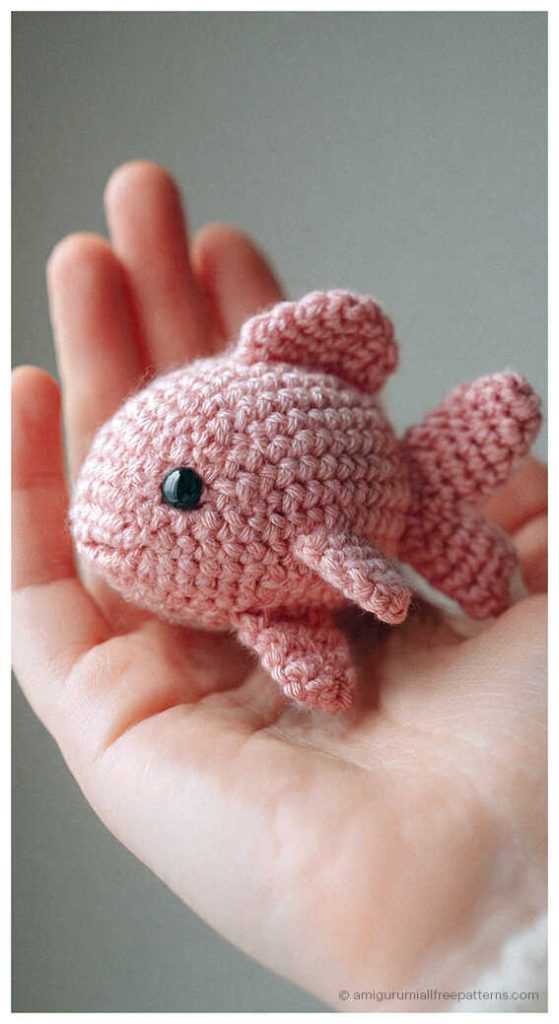 Fish amigurumi crochet toy held in hand, cute mini plush you’ll want to make for nursery decor or a sweet handmade gift.