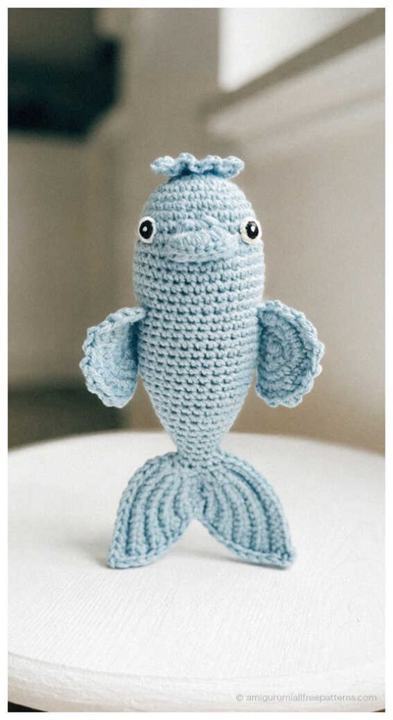 Fish amigurumi crochet doll in soft blue yarn, adorable handmade plush perfect for nursery decor or a thoughtful crochet gift.