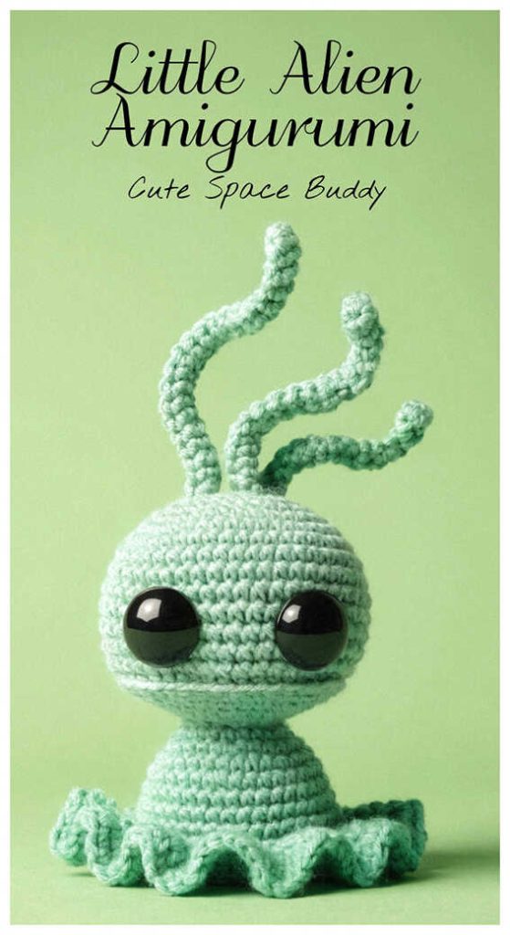Little alien amigurumi crochet doll with long antennae and big eyes, styled as a cute handmade space themed plush for desk decor or gift idea.