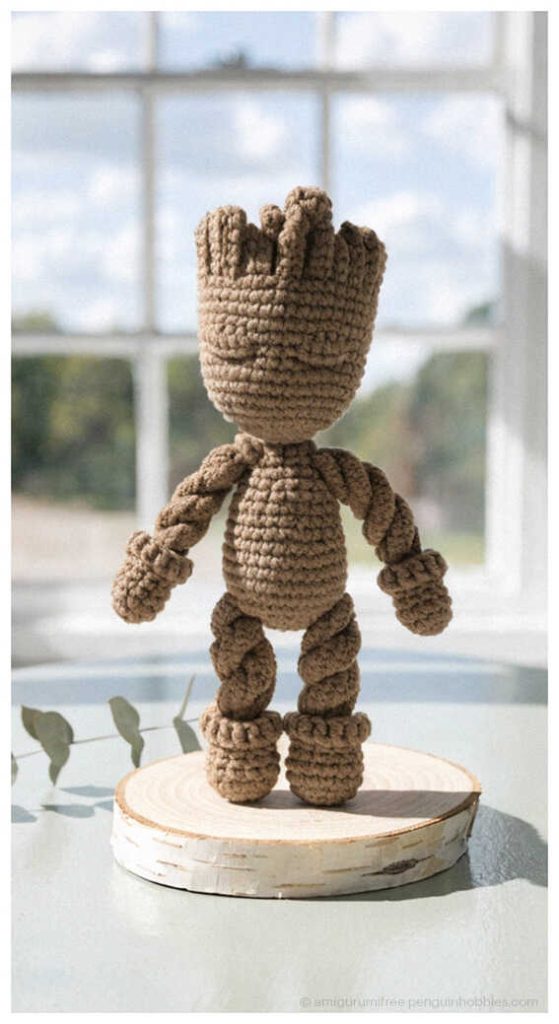 Standing Baby Groot amigurumi crochet figure displayed by window, styled as a handmade Marvel desk decor piece for Groot fans and collectors.