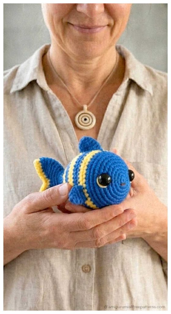 Fish amigurumi crochet toy held in hands, cute handmade plush you’ll love for nursery decor or a unique crochet gift idea.