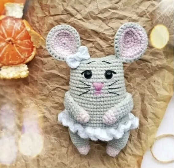 Cute mouse amigurumi crochet doll with pink ears and ruffle skirt, handmade plush toy design, free crochet pattern for a sweet handmade gift idea.