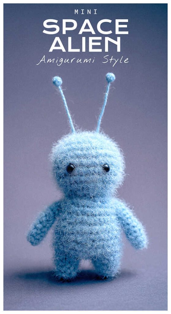 Mini space alien amigurumi crochet plush with antennae, styled as a cute handmade sci fi character toy for desk decor or collectible gift.