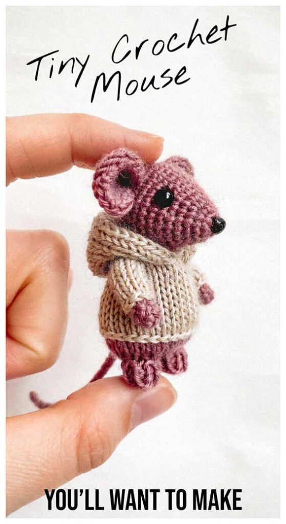 Tiny mouse amigurumi with scarf held between fingers, styled as a cute handmade crochet mini plush toy for nursery decor or sweet gift idea.