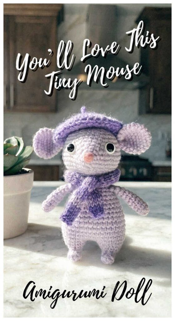 Purple mouse amigurumi crochet doll standing on kitchen counter, styled as a handmade plush toy for nursery decor or baby shower gift idea.