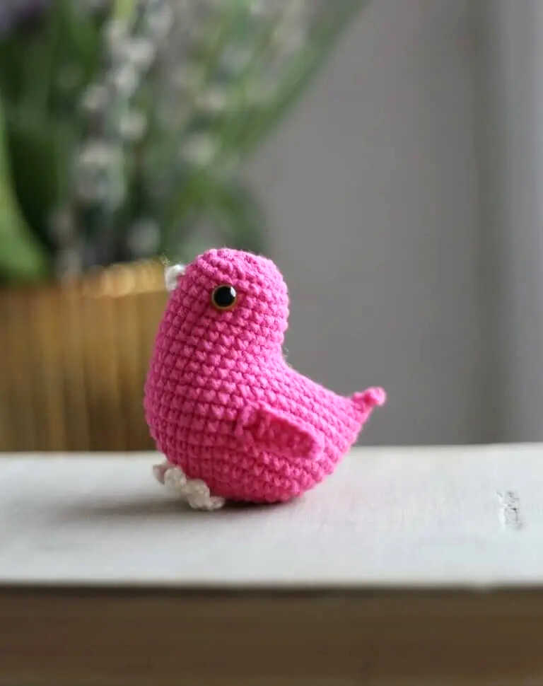 Little bird amigurumi crochet toy in pink yarn, free crochet pattern available, perfect for cute handmade gifts and simple spring decor ideas.