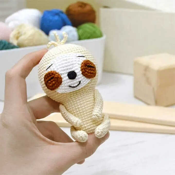 small sloth amigurumi free crochet pattern cute mini plush held in hand