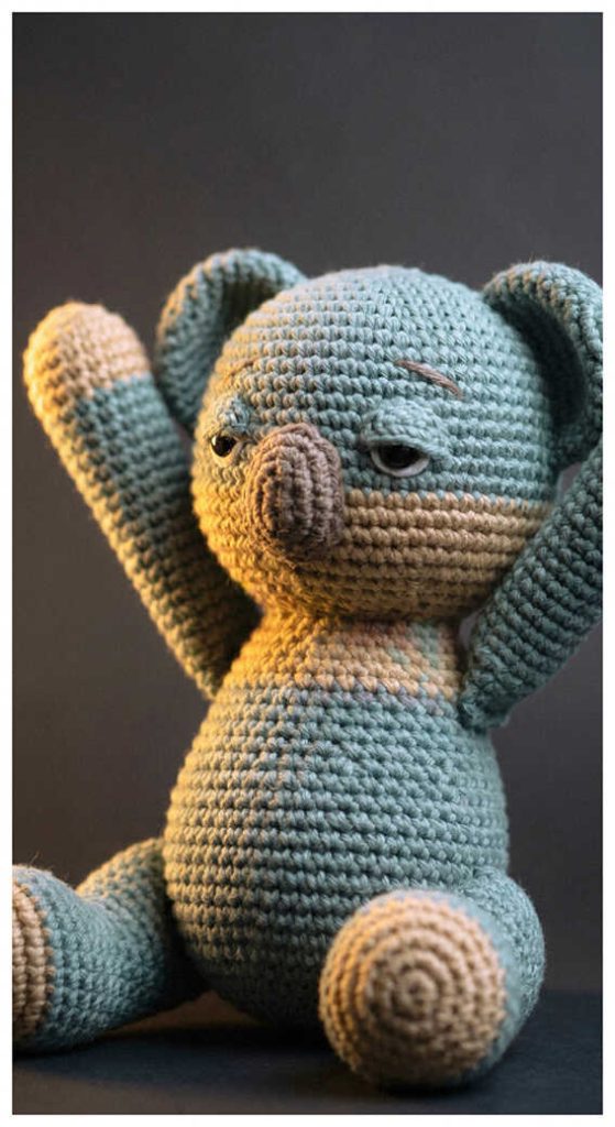 Blue koala amigurumi plush displayed in warm cozy lighting