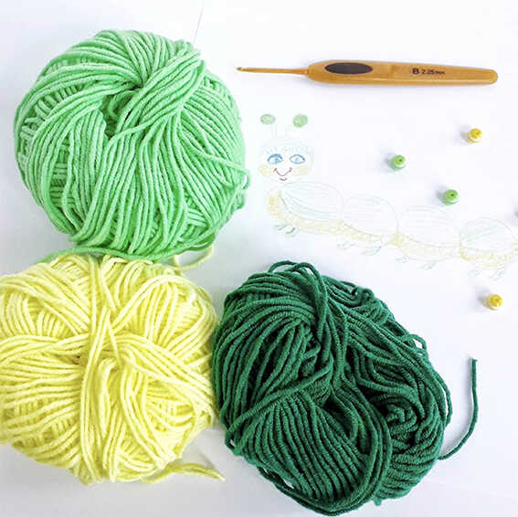 Yarn and crochet materials for caterpillar amigurumi pattern
