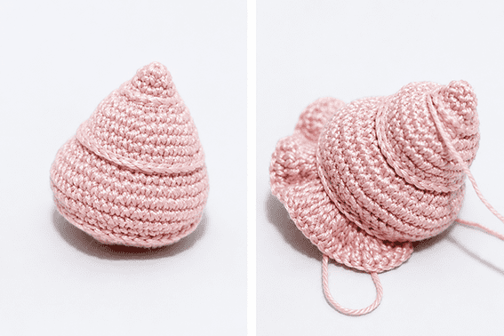 Crochet snail amigurumi assembly stage with shell attached to the body