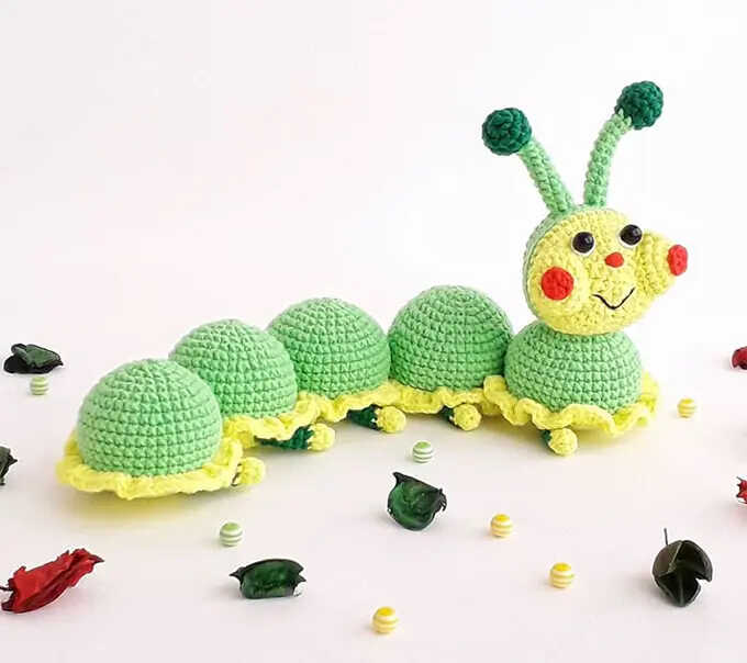 Cute caterpillar amigurumi crochet plush displayed on a clean bright background
