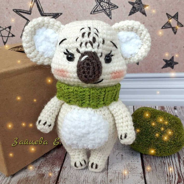 Cute koala amigurumi crochet plush wearing a green scarf