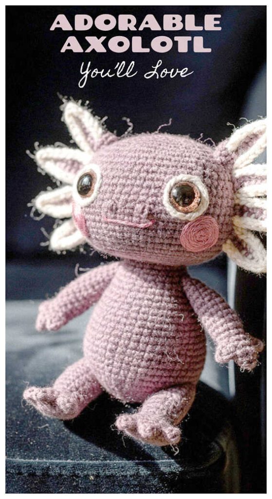 Cute pink axolotl amigurumi plush displayed on a dark styled background