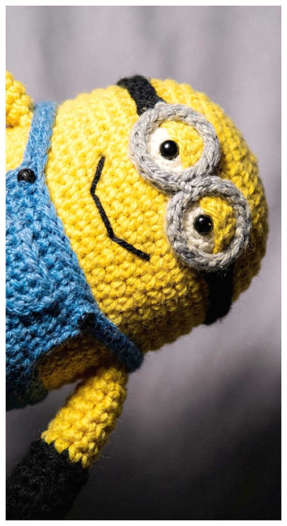 Funny minion crochet plush displayed in a dramatic close up angle