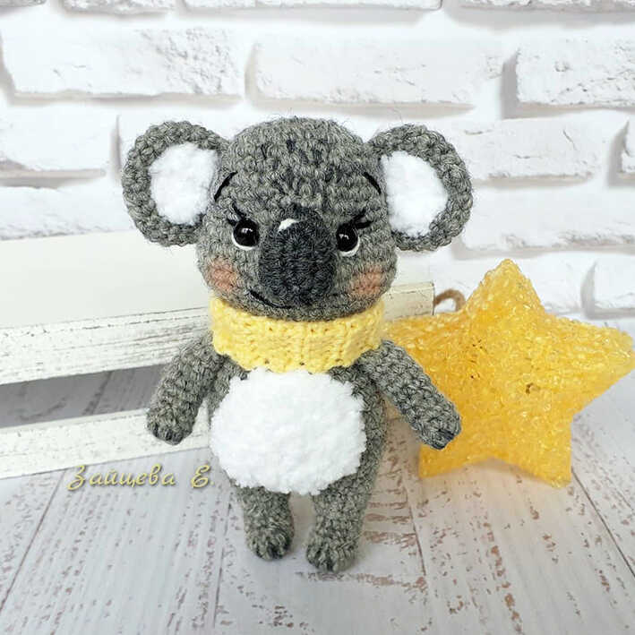 Gray koala amigurumi crochet plush wearing a yellow scarf
