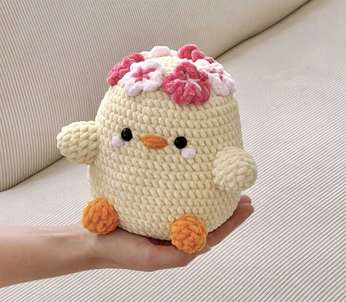 Kawaii crochet duck amigurumi plush held in hand