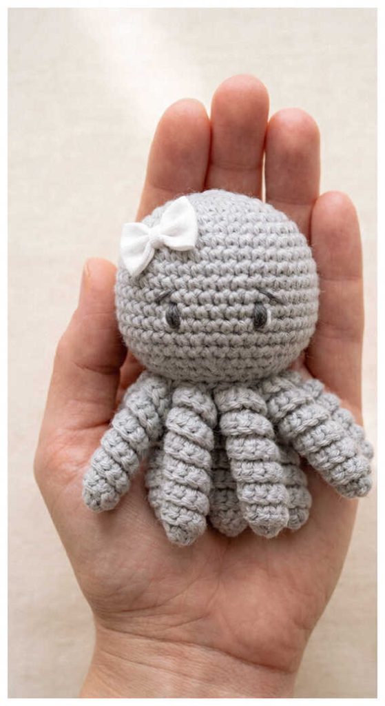 Mini octopus crochet plush held in hand as a handmade gift idea
