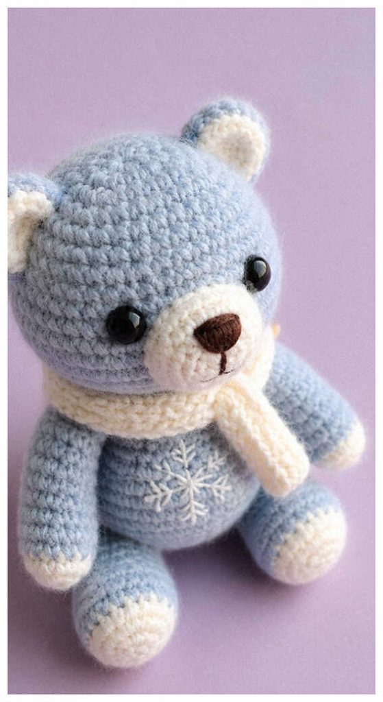 Pastel blue bear amigurumi plush displayed in bright soft lighting