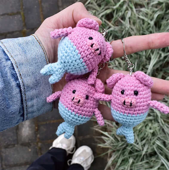 Pig mermaid crochet keychain collection held in hand outdoors