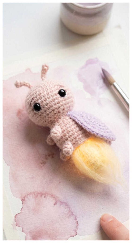Pink firefly crochet plush toy with glowing tail