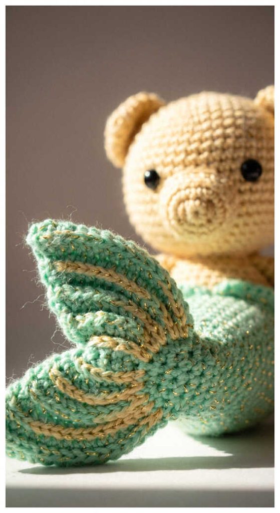 Tiny mermaid pig plush sitting in warm natural light