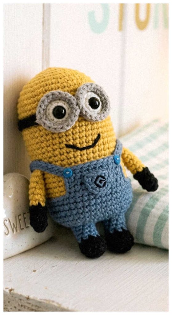 Tiny minion amigurumi plush displayed in a bright indoor setting