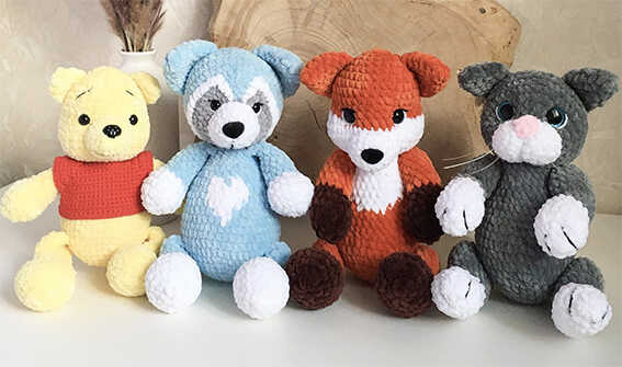 Woodland amigurumi crochet plush toys including fox, bear, raccoon, and cat
