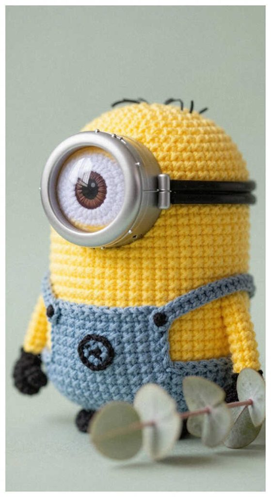 Yellow minion amigurumi plush displayed in a clean bright setting