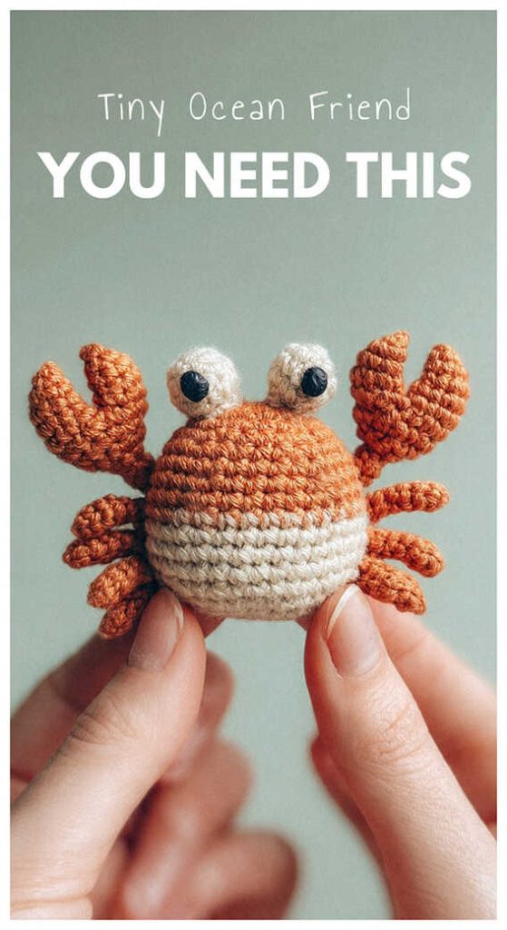 Tiny crab amigurumi crochet plush toy held in hand